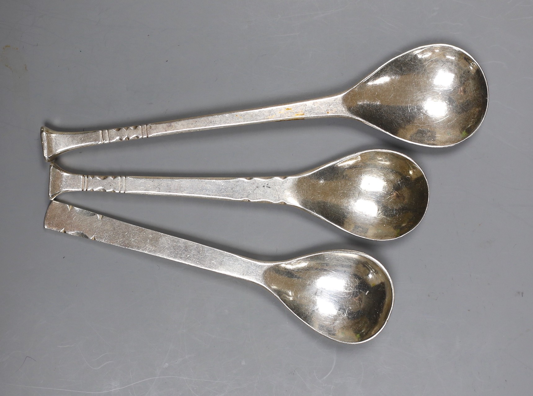 Three assorted modern Art s& Crafts Guild of handcrafts spoons, London, 1968, 1978 & 1980, one with rat on the back of the bowl, longest 17.5cm, 154 grams.